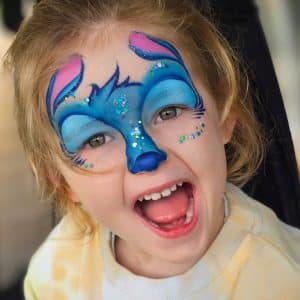 A child with Stitch face painting