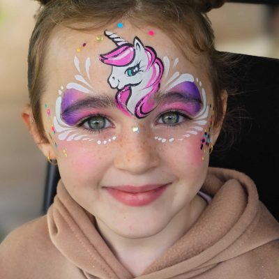 A child with a unicorn face painting
